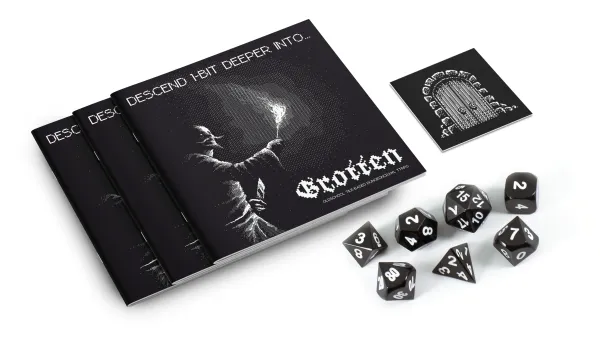 Mockup of the black and white Grotten zine, dungeon tiles, and dice...